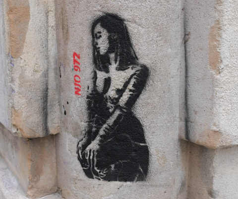black stencil artwork on stone wall, woman portrait by William Njo