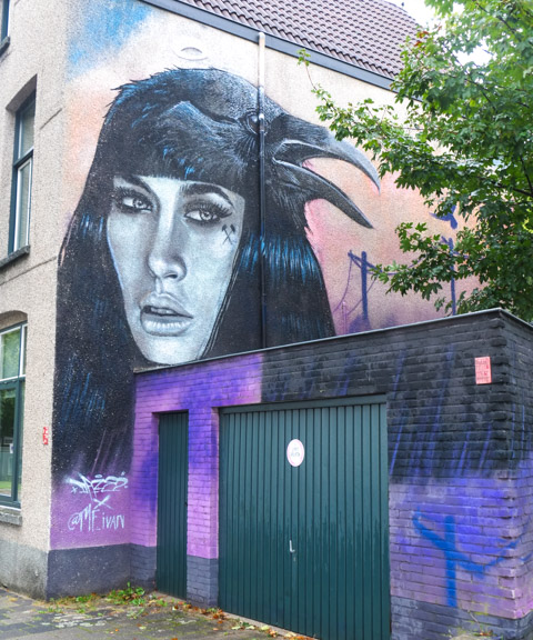 mural on the side of a house, a woman 