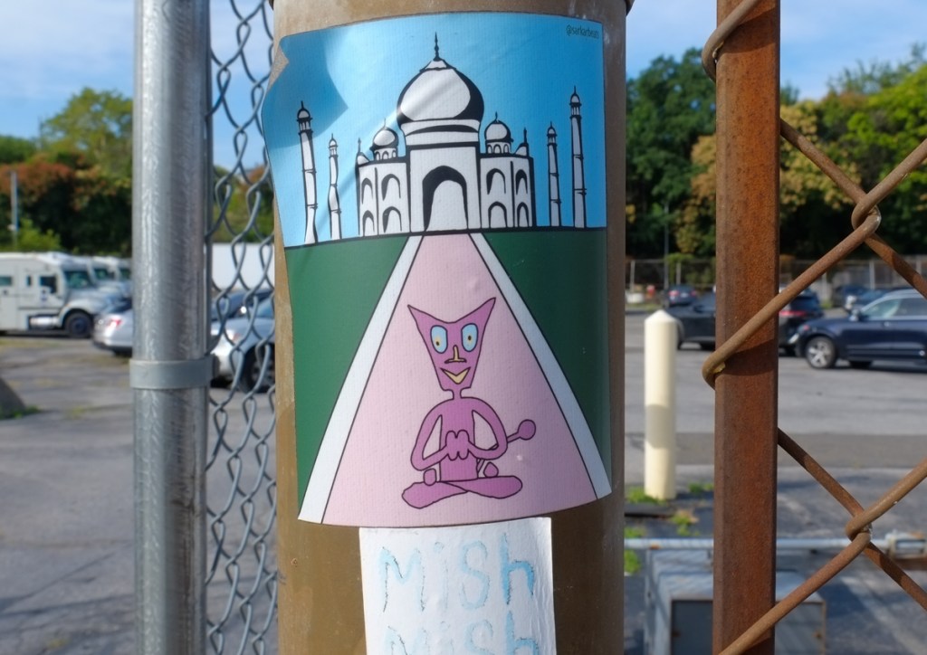 Dpac, in yoga position in front of drawing of the taj mahal