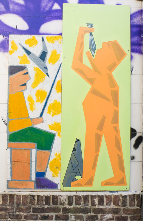 mural in two panels, on left is man fishing and on right is man eating fish