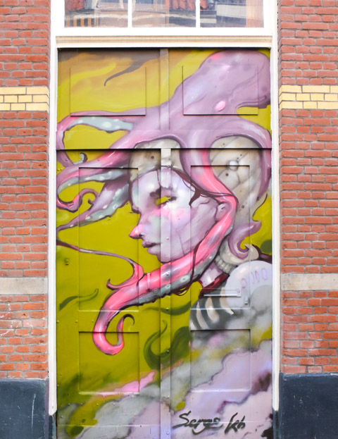 mural on door, pink and purple portrait in profile, greenish yellow background