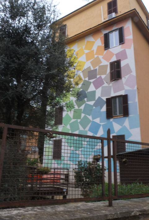 large mural on the side of a four storey apartment building in Tor Marancia, Rome, 93 colored squares by albernonero 