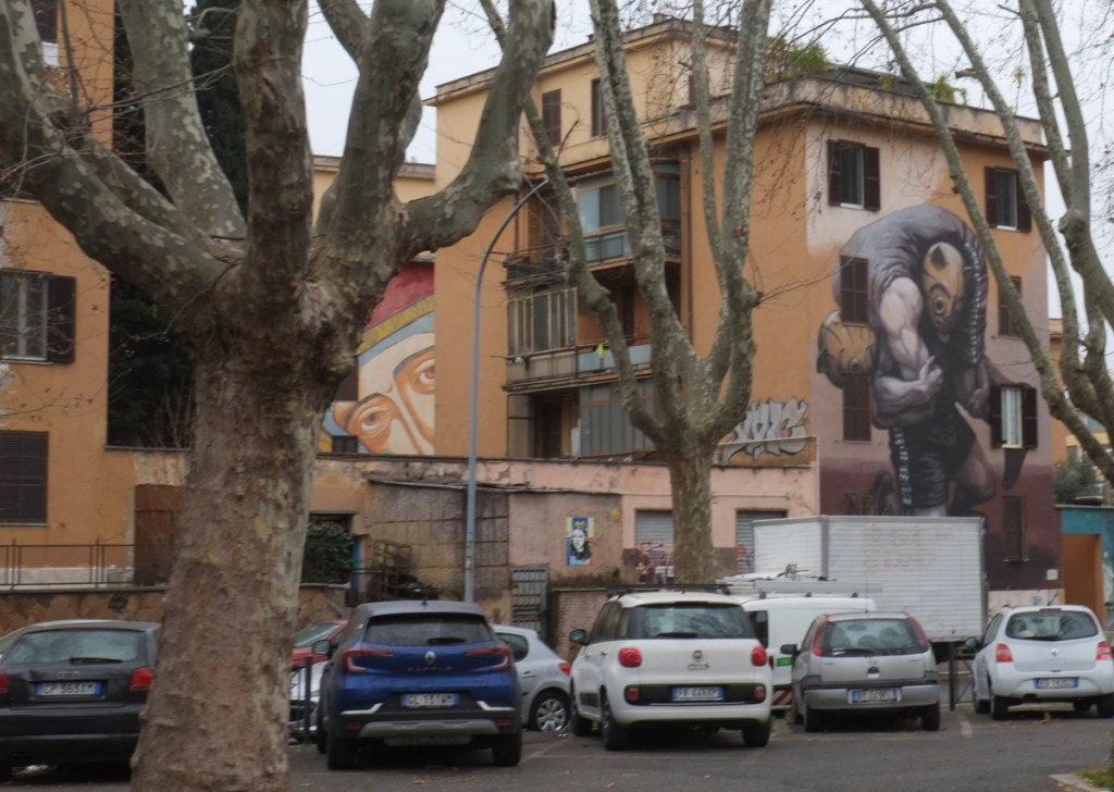 large mural on the side of a four storey apartment building in Tor Marancia, Rome, large mural face peeking out from behind another building