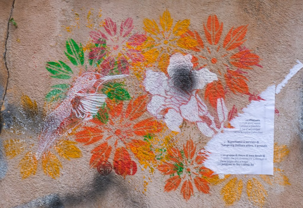 stencil of white hummingbird over colourful flowers, by stew