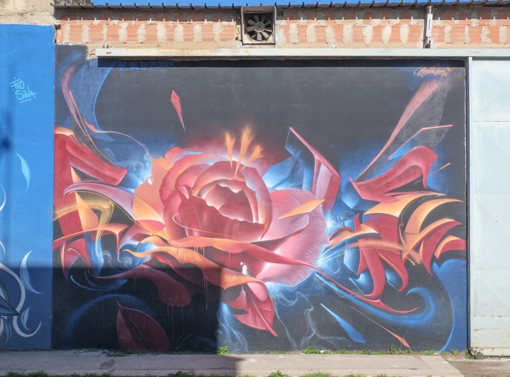 mural of a rose in reds and oranges