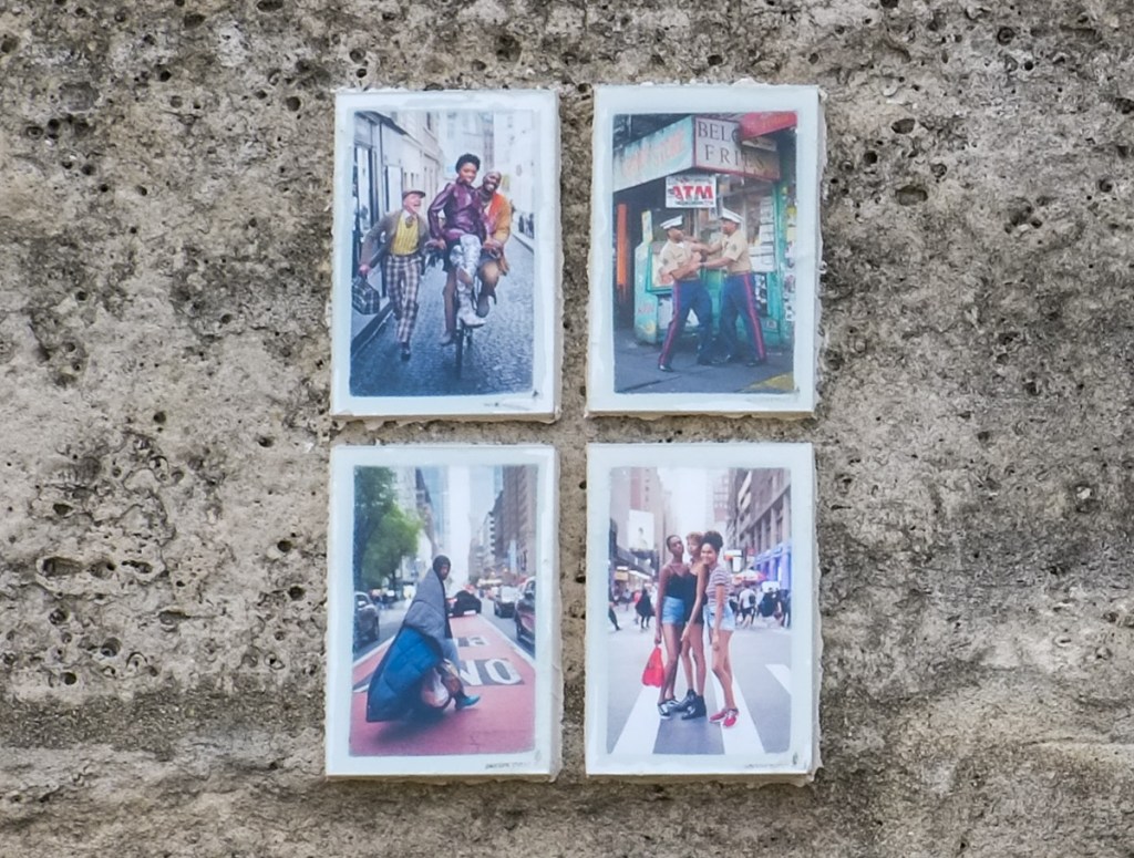 4 small colour photos, framed, on a wall