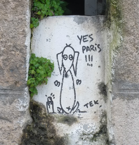 small black and white graffiti, simple drawing of a dog saying yes paris
