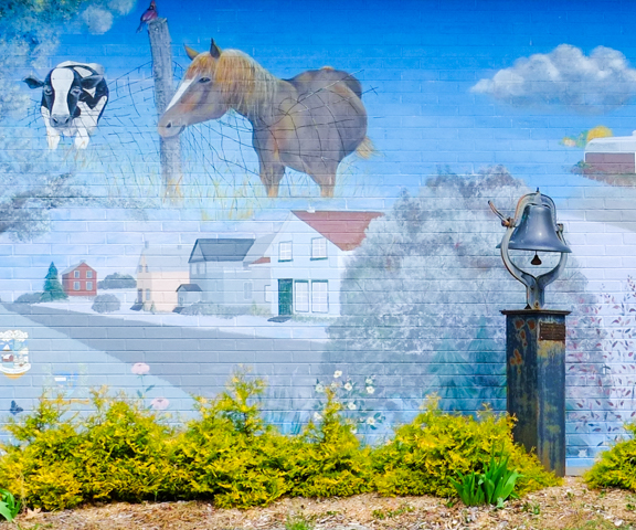 part of a mural on exterior wall of Burnt River post office, some houses, a cow, and a horse
