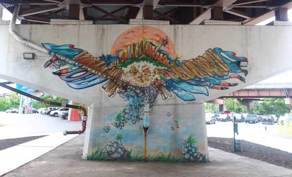 mural on concrete ramp support, bird in flight, many feathers, by john breiner