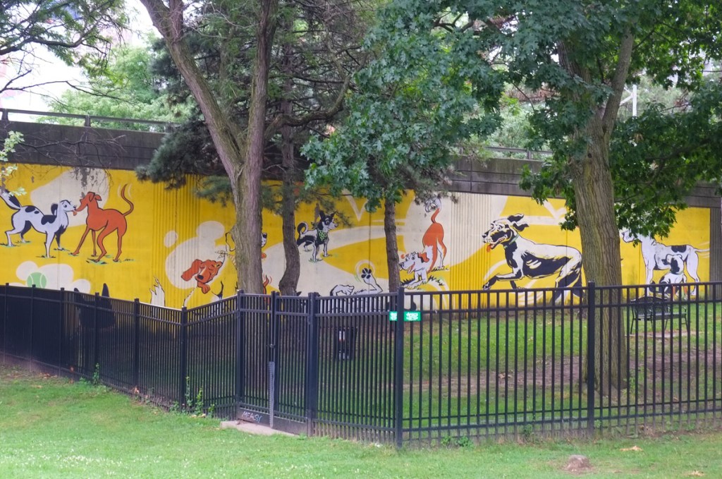 street art mural in a dog park, images of dogs on yellow background