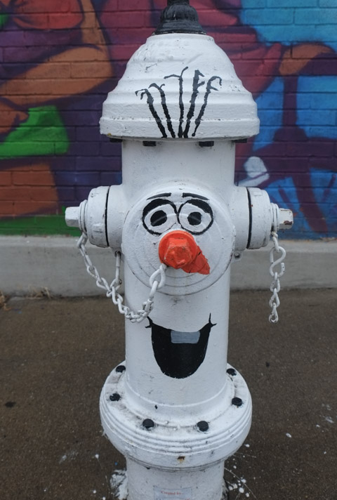 fire hydrant painted like olaf, the snowman in the animated Frozen movie