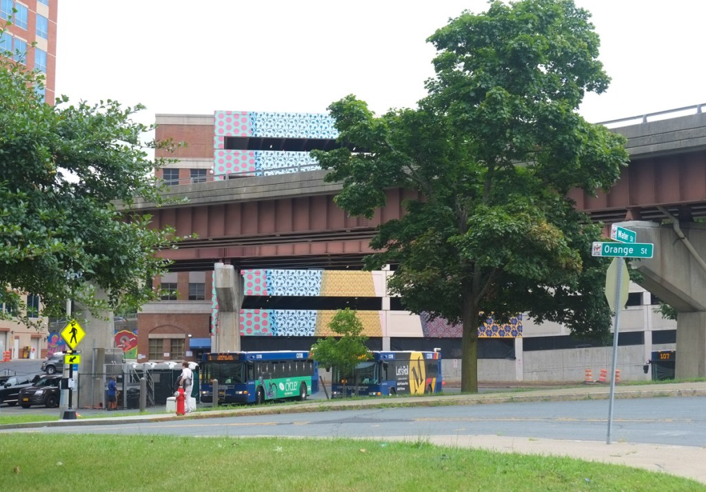 on the side of a parking garage, painted shapes and patterns