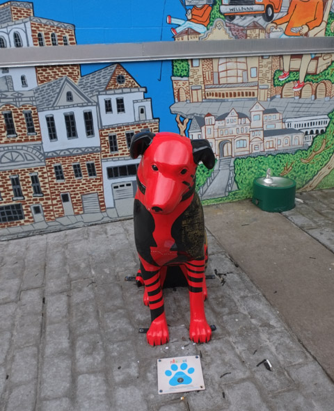 dog sculpture painted in red and black