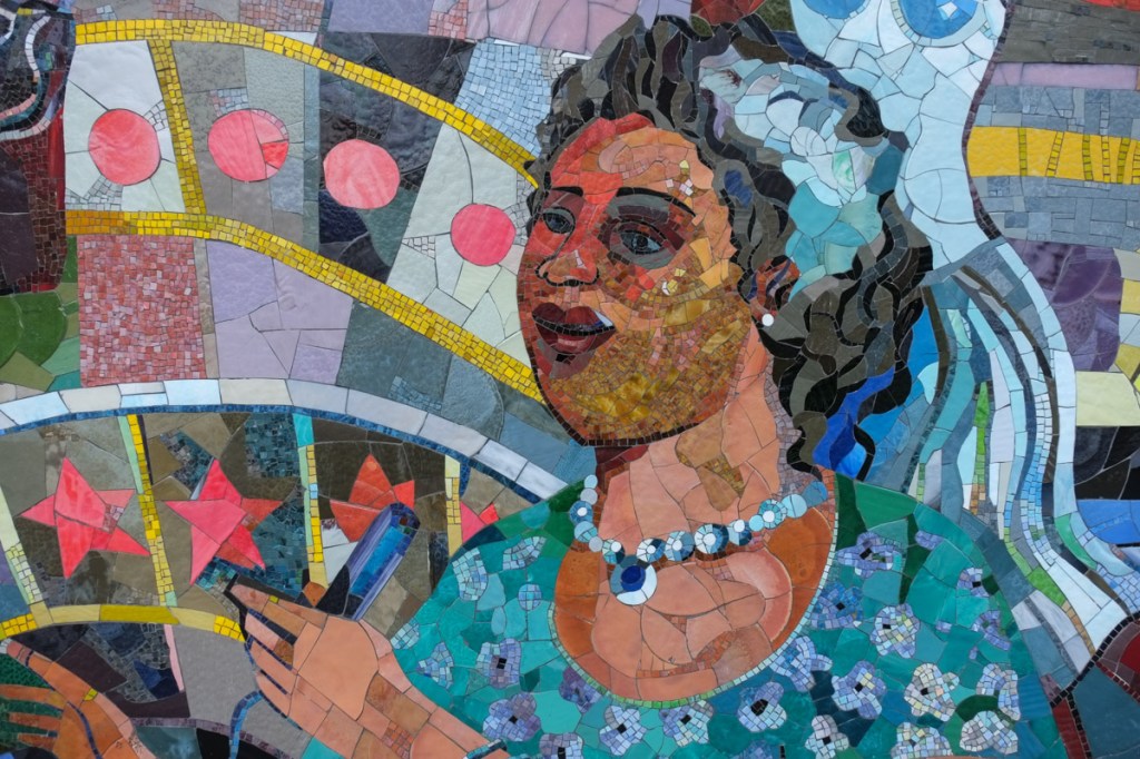 spirit of harlem mosaic mural in new york city, woman with a shiny blue necklace
