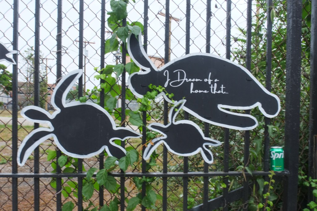 black cut outs in turtle shapes on a black metal fence