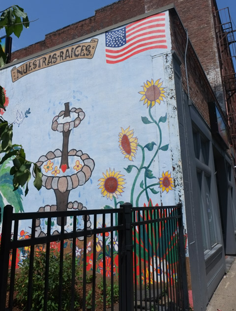 part of a mural with a fountain and sunflowers