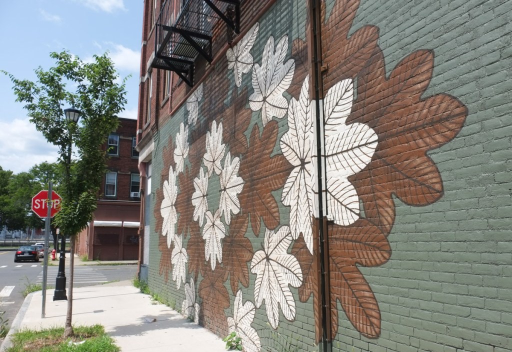 closer view of the brown and white palmate shaped leaves in the rivera mural in holyoke