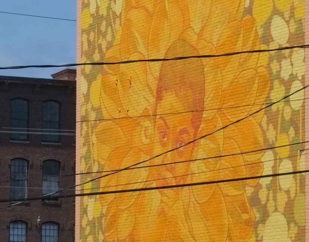 yellow mural by gleo, a boy surround by big yellow flower