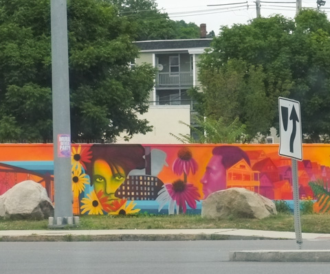 fence in Lowell massachusetts, covered with a colorful mural