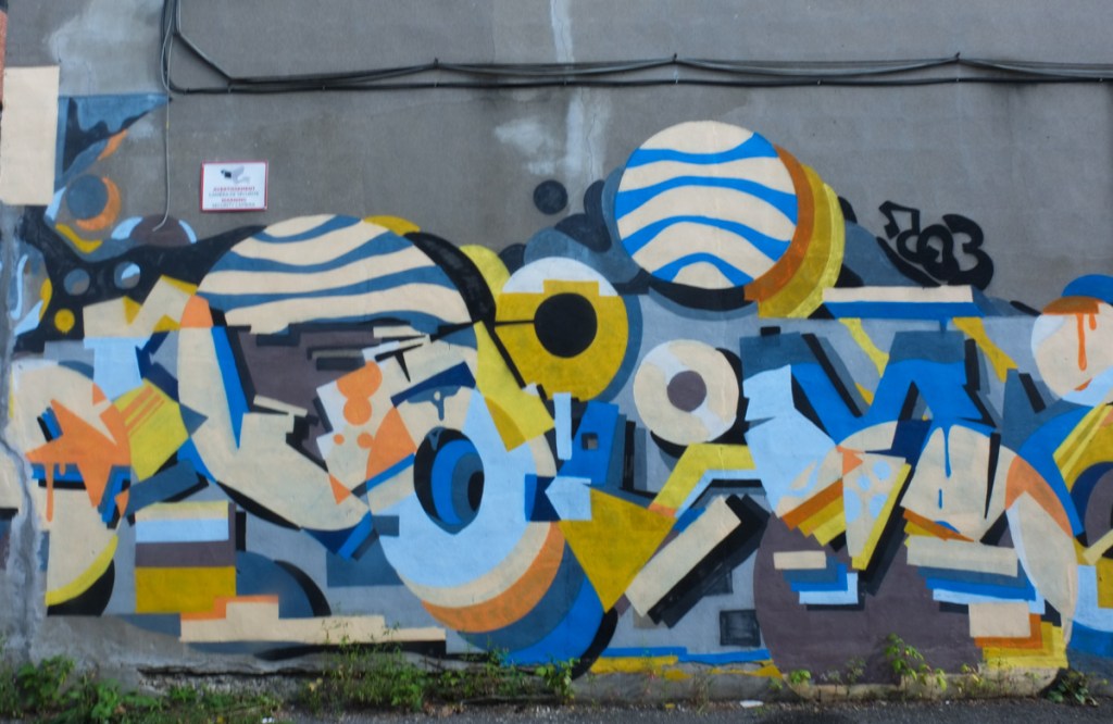 wildstyle graffiti by naimo, or perhaps an abstract mural with shapes and circles