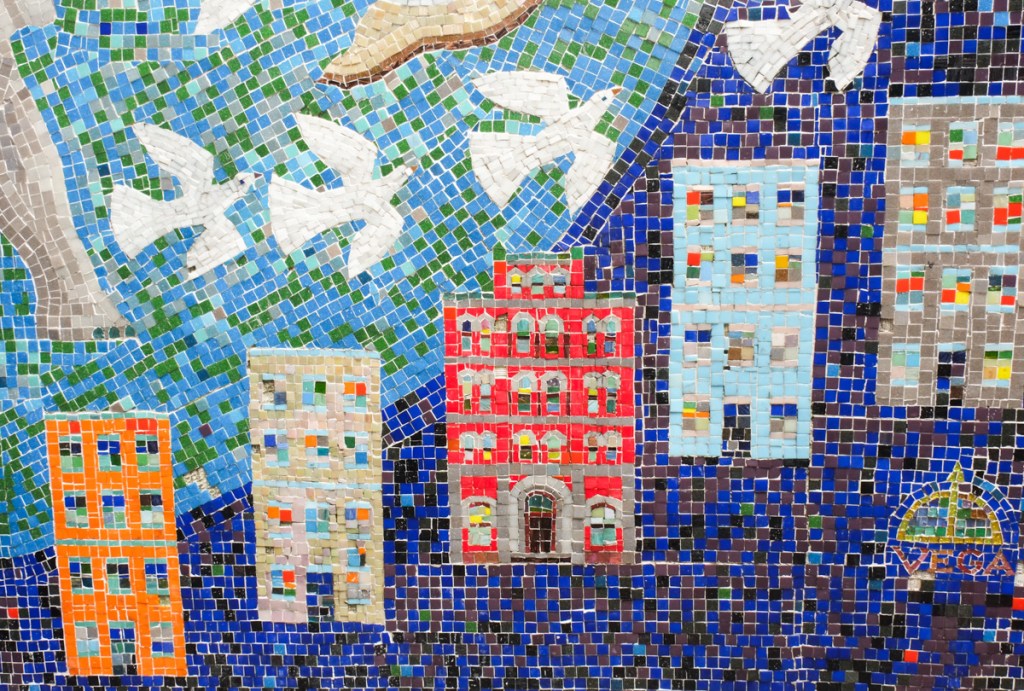 5 four story apartment buildings in bright colours with different coloured windows