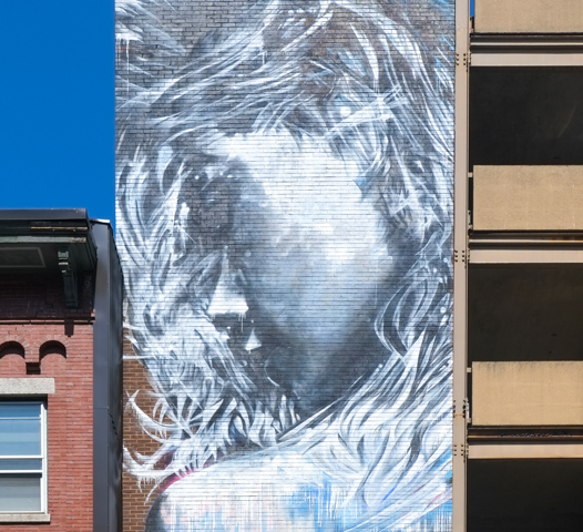 christena angelina mural of a woman in profile, long hair, watery