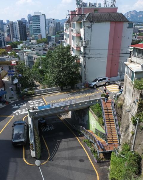 view from ilha village, overlooking seoul, bridge, road with big curve, coffee shop, houses, roofs, 