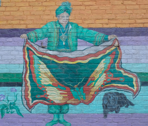 circus performer with large square scarf, magic act