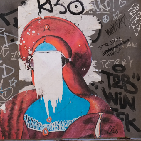 blub graffiti that was a portrait wearing a diving mask, but has been torn so face is gone