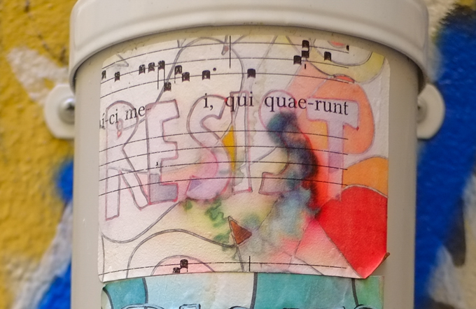 paste up with the word resists written in large letters aver music score