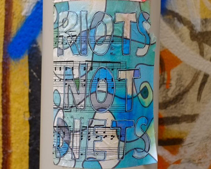 riots not diets are the words written on this paste up