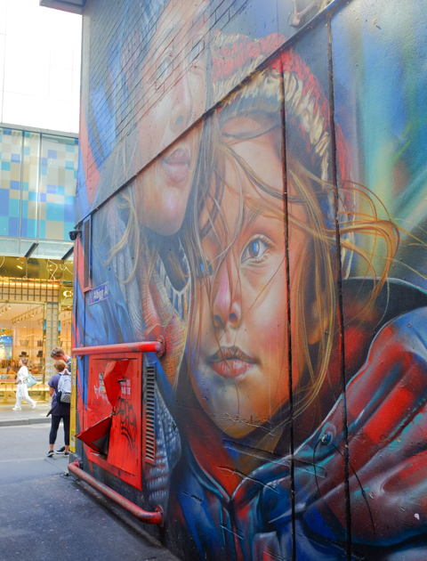 Adnate mural of mother and child on a wall in Albany Alley