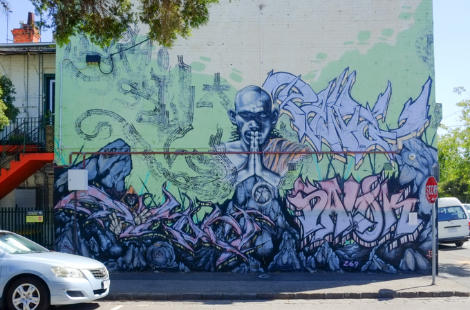 mural of a man with hands closed in prayer
