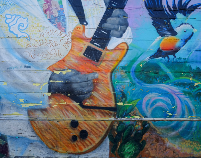 small part of Large 60 foot mural in Mission District celebrating the Santana family, Carlos Santana's hand playing a guitar