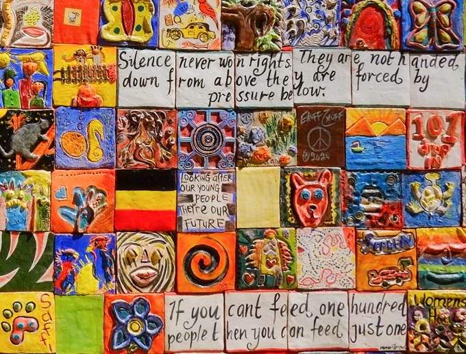 hand decorated ceramic tiles arranged in a mosaic as street art on a building in a park in Port Phillip Australia