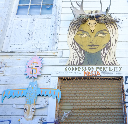 goddess of fertilty Fija sign over door and under an image of a woman with long white hair, a crown of antlers,