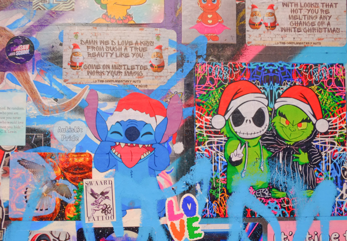 Christmas theme graffiti including characters from the Nightmare Before Christmas, a pokemon character, and some Santa gnomes with text