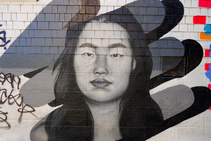 black and white and grey tones, portrait of a young woman, with long dark hair,
