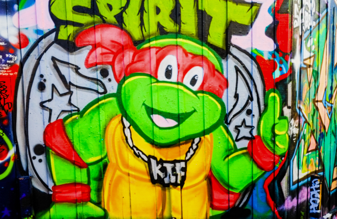 teenage mutant ninja turtle mural, with red masked turtle, Raphael, wearing clunky gold necklace