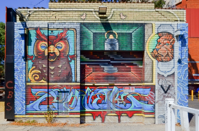 mural with a brown owl on the left and a lion's head on the right top,