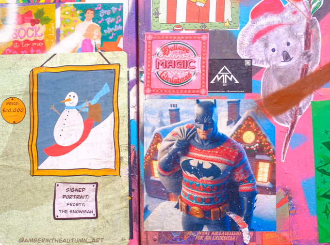 Christmas theme graffiti including Batman in a Christmas sweater and carrying a big bag of toys on his back, also image of snowman sledding down a snow covered hill