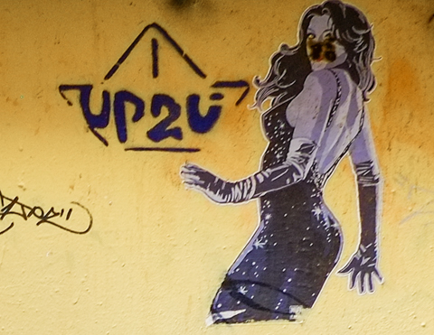 black and white graffiti, small, of a woman turning to look at viewer. 