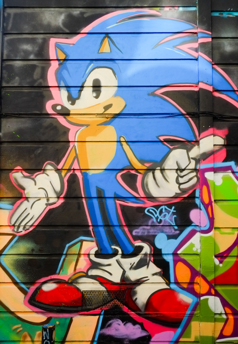 street art painting of sonic character, with long blue hair, and big white hands