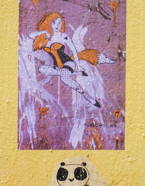 graffiti poster, by susi foxy art, woman with fox fur including tail, corset in orange and black, fox coloured hair, fishnet stockings, 