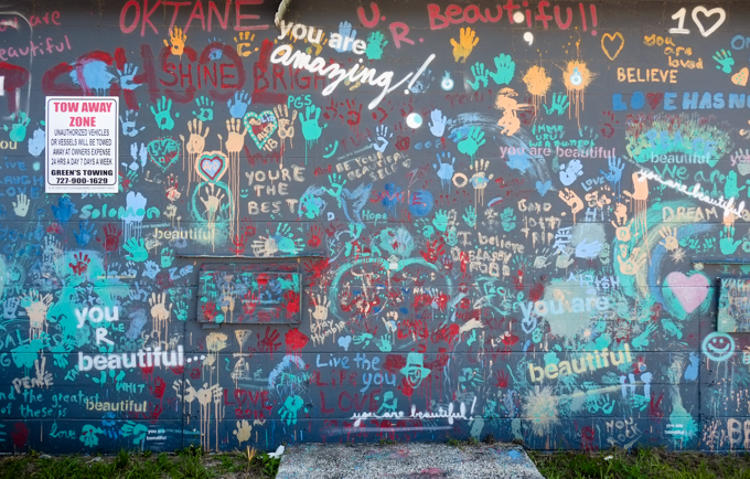 wall covered with words and messages such as you are beautiful, stand for peace and love, you re amazing, believe, you're the best