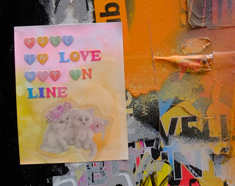 paper paste up graffiti, with words fall in love