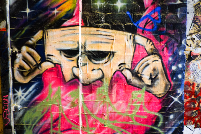 putting on a mask, part of a street art painting