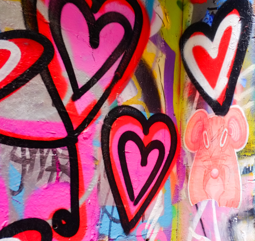 spray painted street art hearts in Hosier Lane, along with a pink mouse sticker