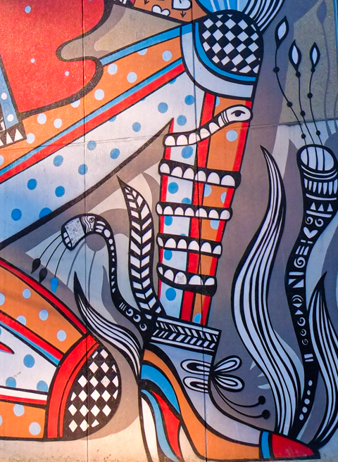 close up of knee and foot, with boot, in a mural by Ola Vola, Wall for Women