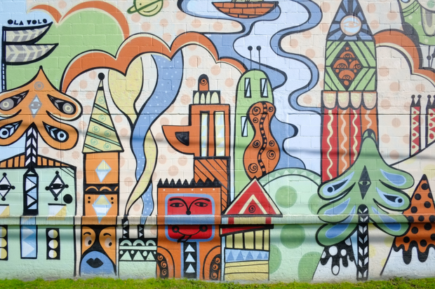 part of a mural by Ola Volo called Van City Scape, stylized elements of a city, some with faces